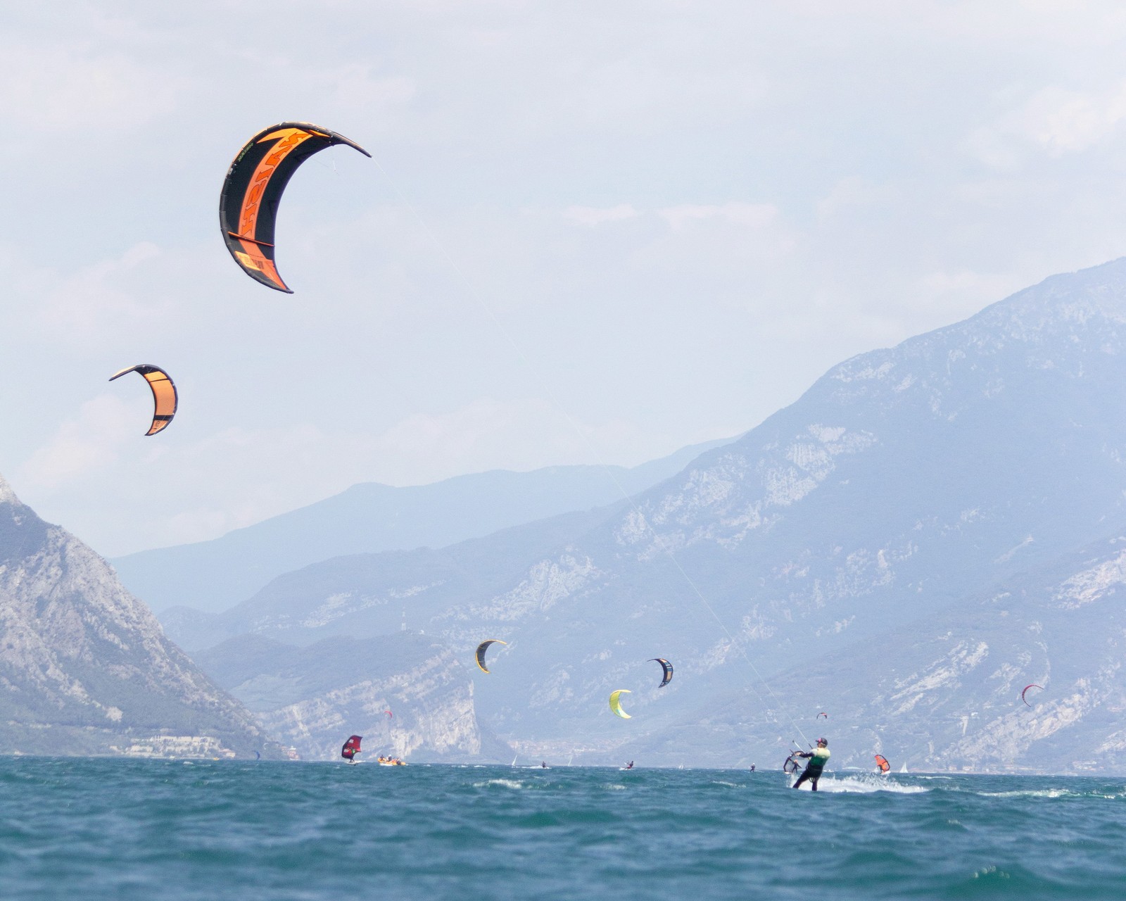 Kite surfers catching the wind on Lake Garda, Italy.