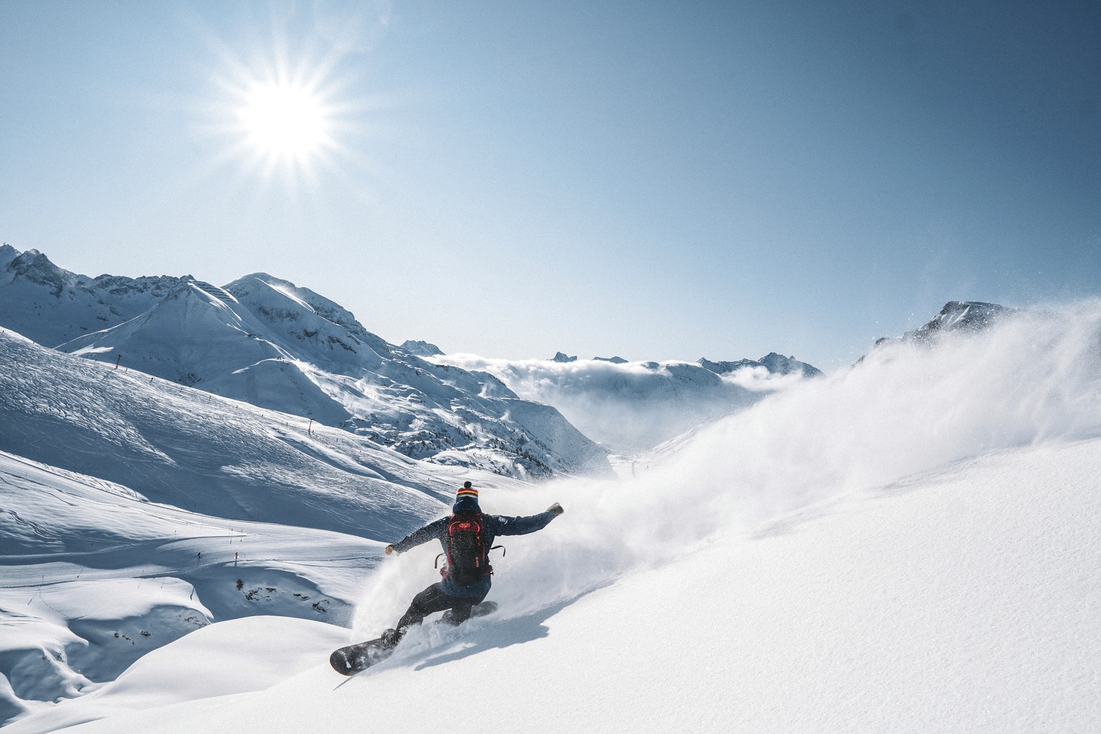 A snowboarder carves fresh powder in St. Anton, Austria.