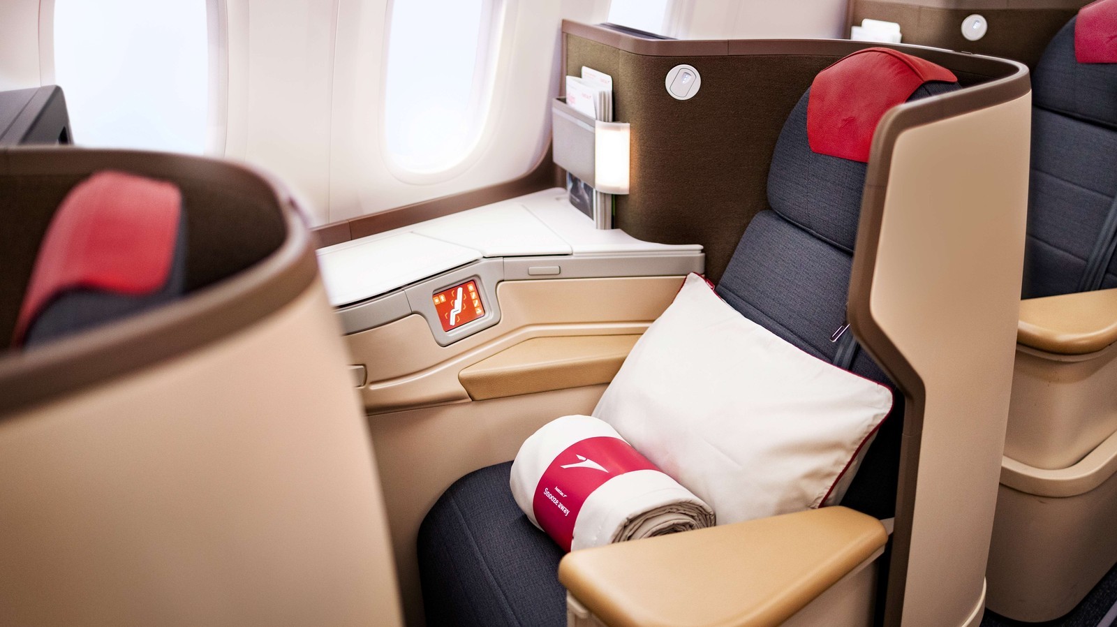 Lie-flat Business Class seat on the Austrian Airlines Boeing 787 Dreamliner, designed for restful long-haul travel. Photo by Austrian Airlines.