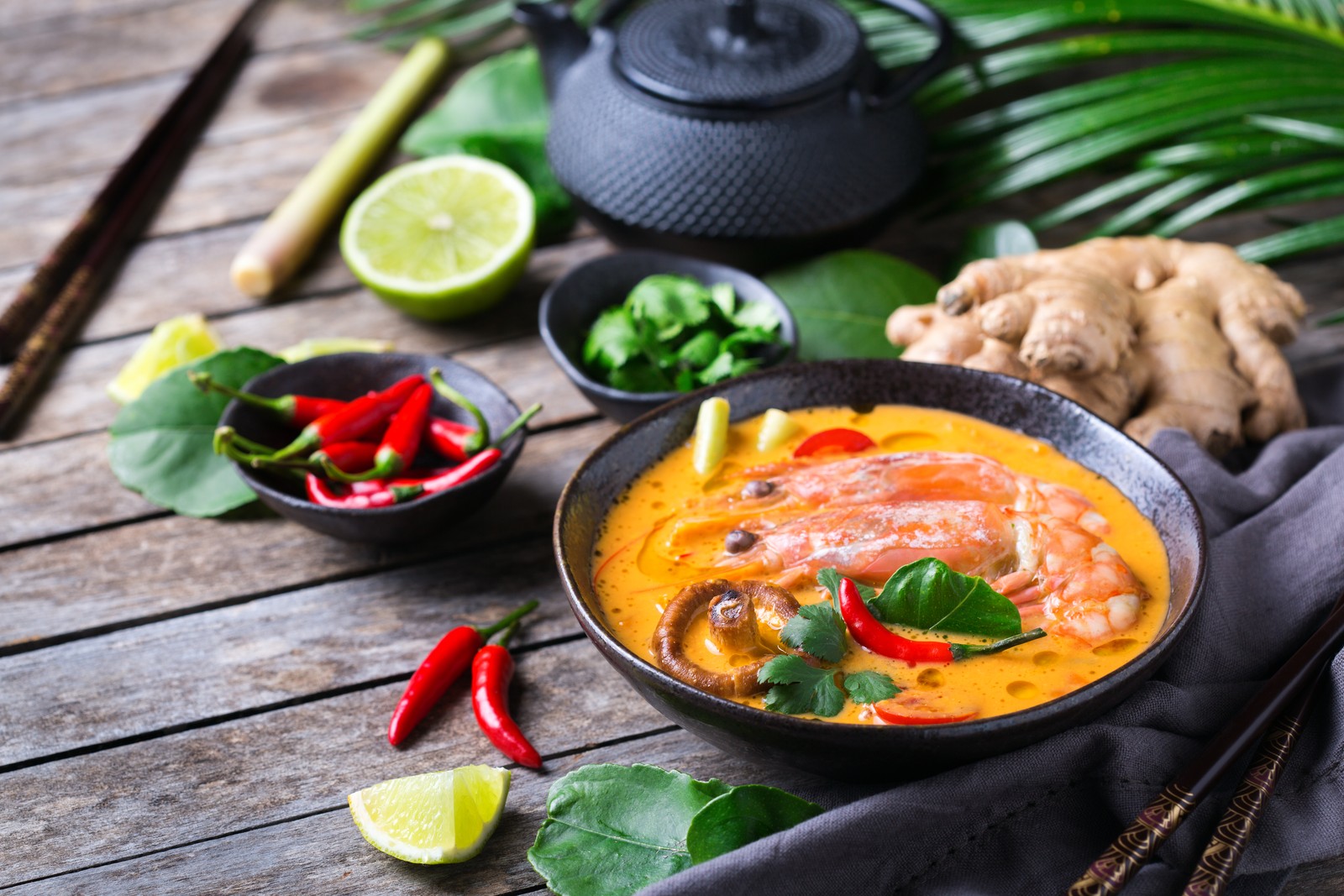 Tom Yum Goong - spicy, sour, and full of flavor, Thailand’s most famous soup served with fresh herbs and chili.