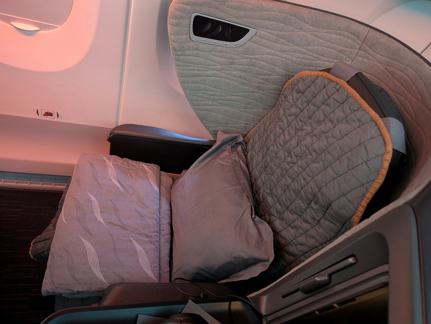 Fully flat Business Class bed on Turkish Airlines with generous sleeping space and ambient cabin lighting for improved rest. Photo by Frugal Flyer.
