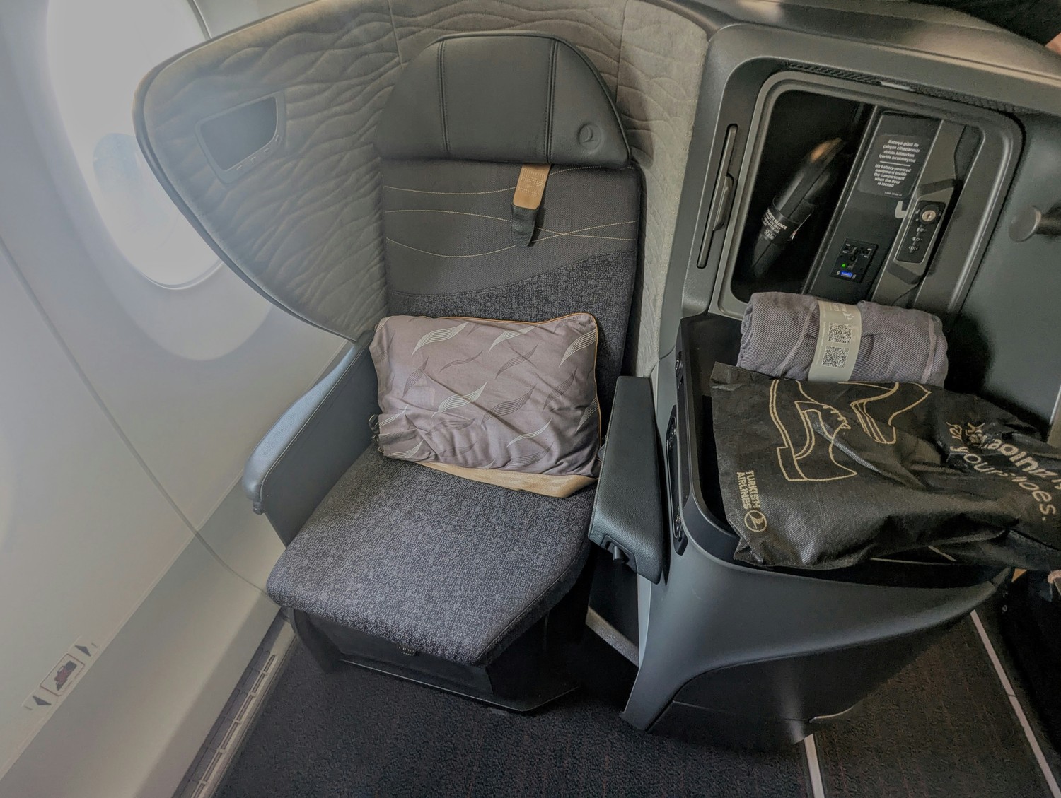 Turkish Airlines Business Class seat viewed from the aisle, highlighting privacy-focused design. Photo by Frugal Flyer.